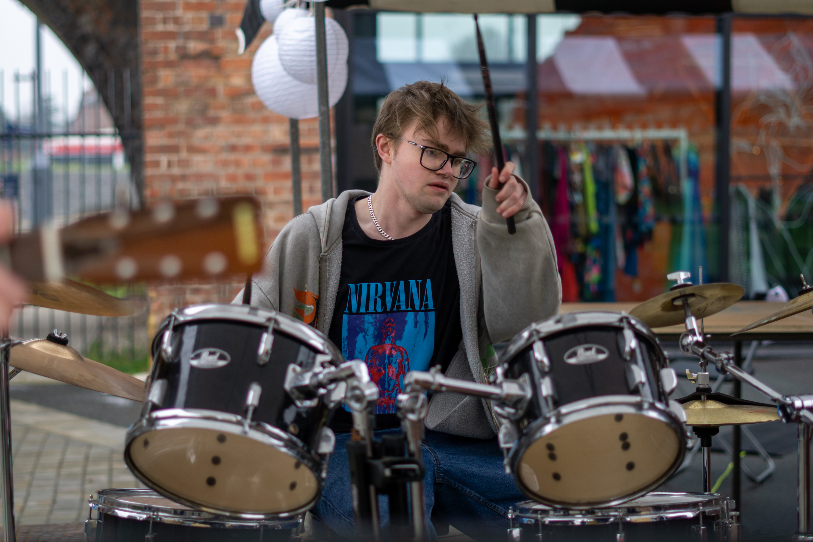 A male drummer in the band performing at Speak Volumes! Festival 2025.