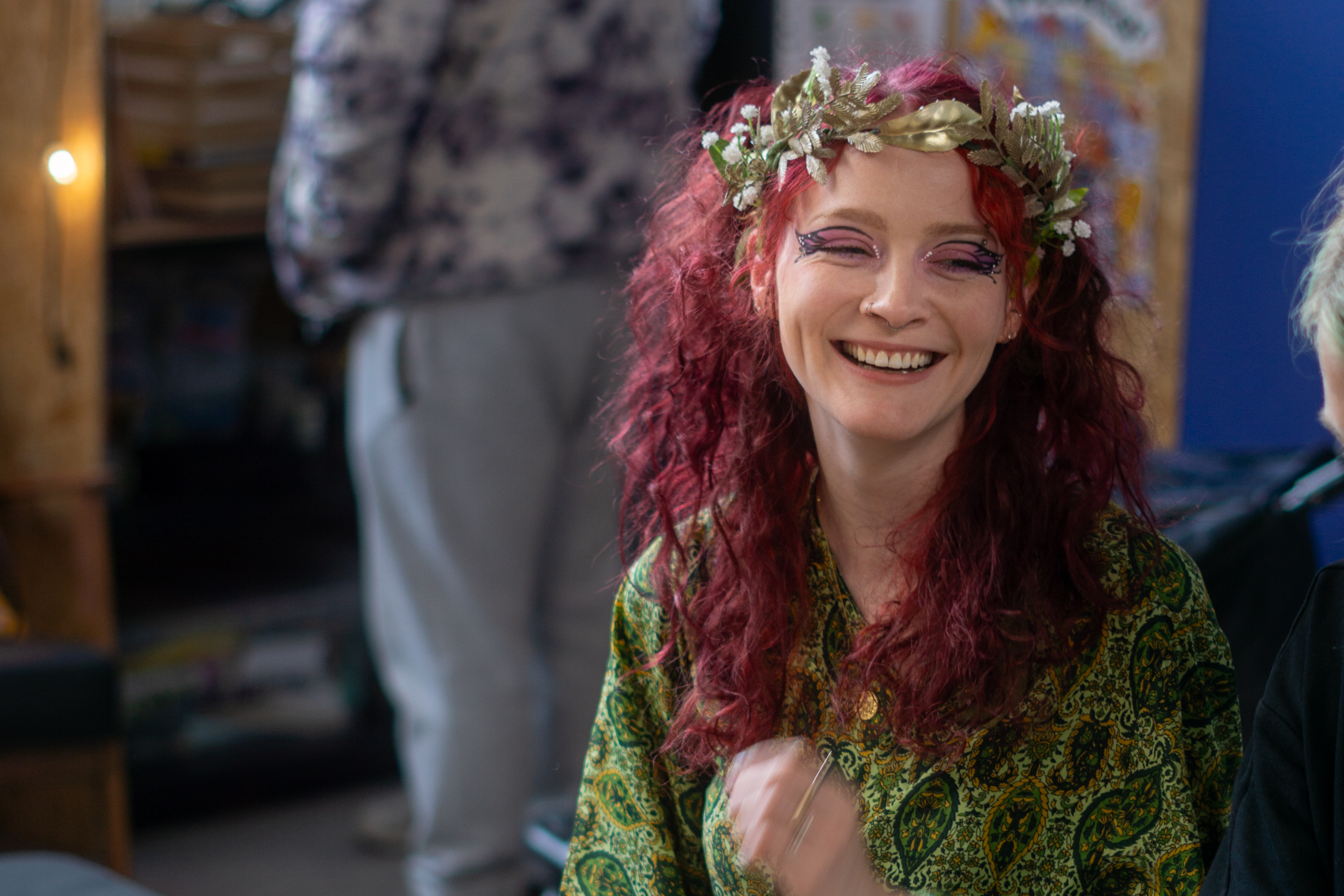 A woman with elaborate eye makeup and red hair in a workshop at Speak Volumes! Festival 2025.