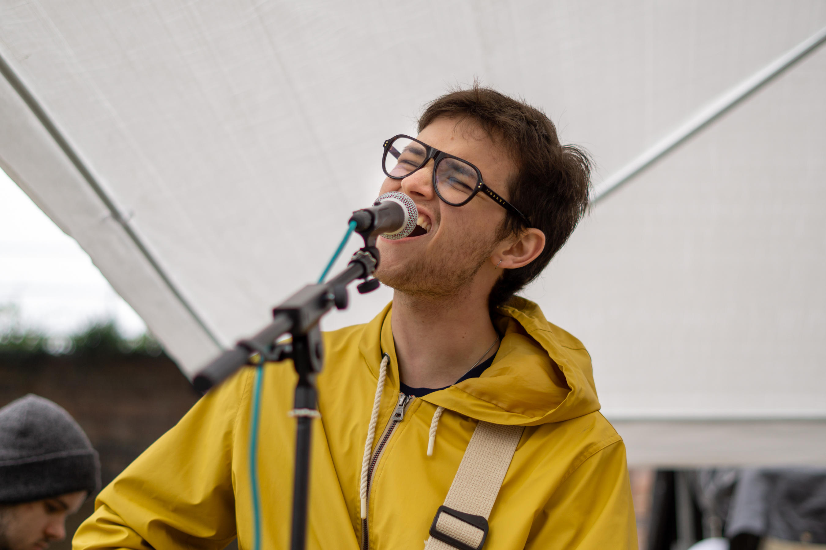 The male singer of the band at Speak Volumes! Festival 2025 singing into the microphone.